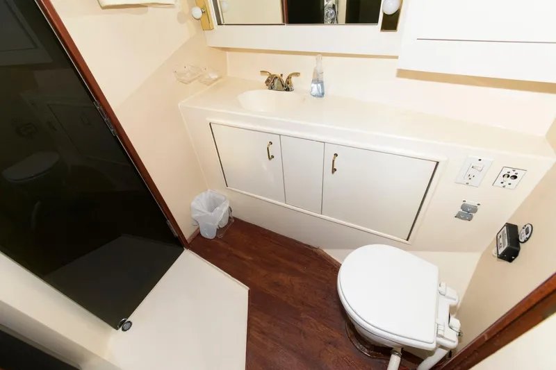 Slide: The Image of 1985 Ocean Yachts 46 Aft Cabin Motor Yacht bathroom with shower, sink, and toilet. - 24