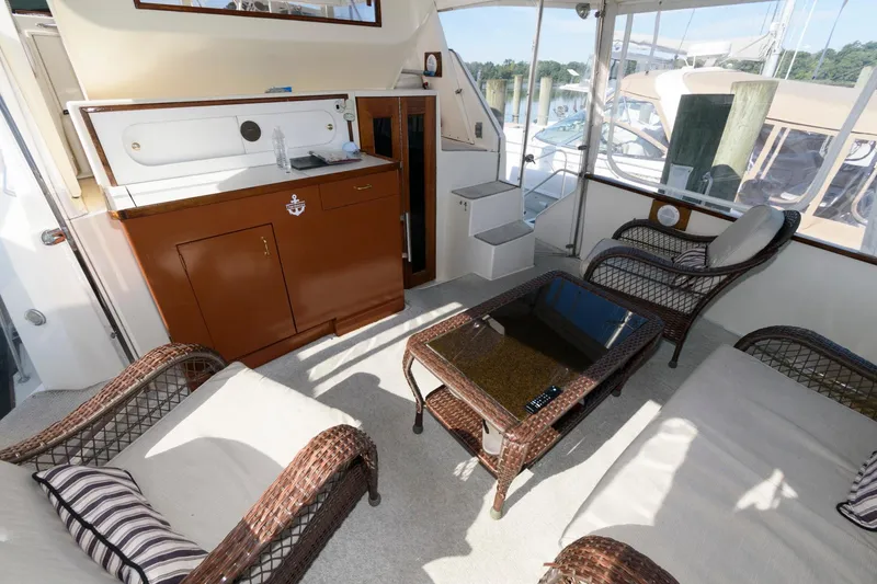 Slide: The Image of 1985 Ocean Yachts 46 Aft Cabin Motor Yacht interior with wicker furniture and kitchenette. - 5