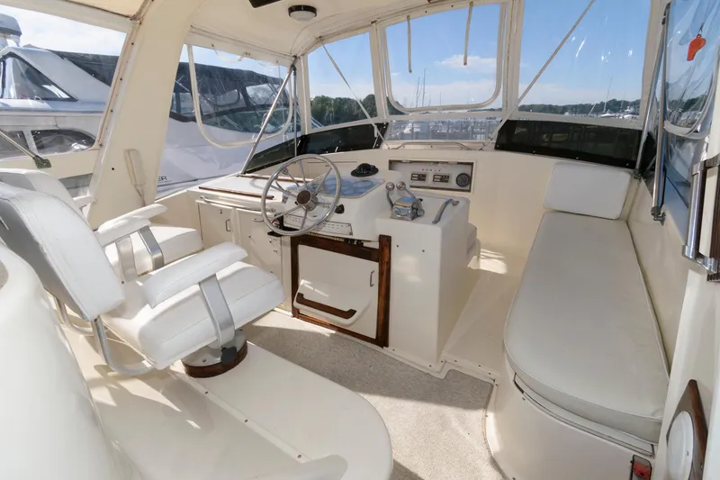 Slide: The Image of 1985 Ocean Yachts 46 Aft Cabin Motor Yacht helm with seating and steering wheel. - 7