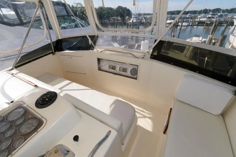 Slide: The Image of 1985 Ocean Yachts 46 Aft Cabin Motor Yacht helm with gauges and seating, dockside view. - 9