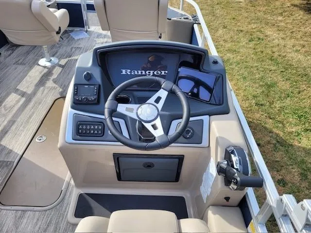 Slide: The Image of 2024 Ranger Reata 223F boat dashboard with steering wheel and controls. - 3