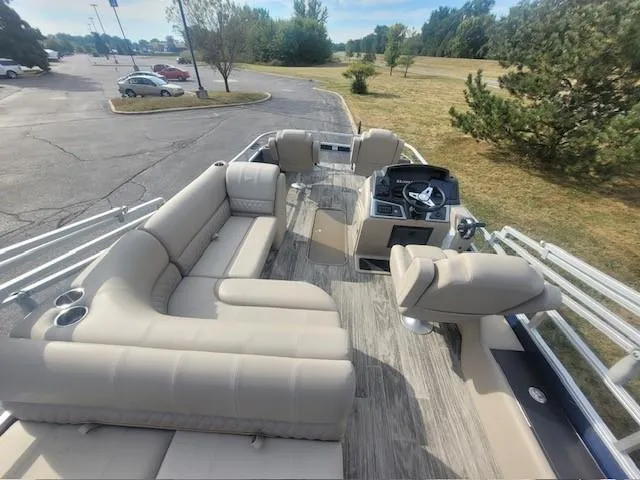 Slide: The Image of 2024 Ranger Reata 223F pontoon boat with spacious seating and modern helm. - 4