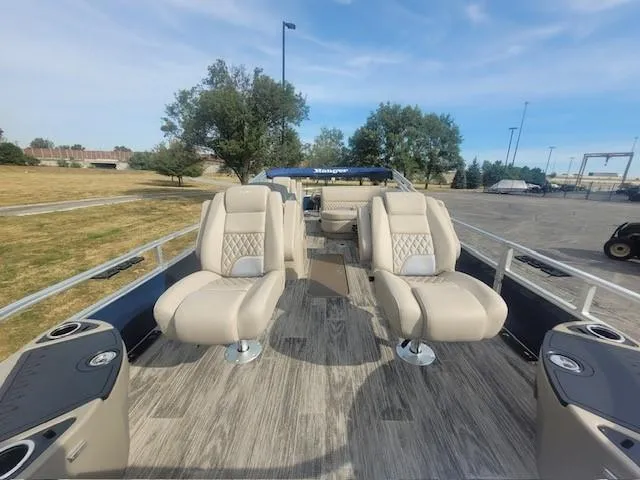 Slide: The Image of 2024 Ranger Reata 223F pontoon boat with plush seating and spacious deck. - 5