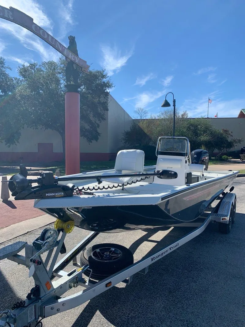 Slide: The Image of 2024 Ranger RB200 boat on trailer under clear blue sky. - 1