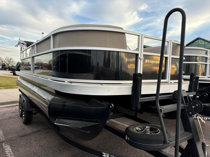 Slide: The Image of 2024 Ranger Reata 200C pontoon boat with sleek black exterior and modern design. - 1
