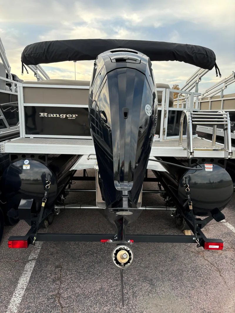 Slide: The Image of 2024 Ranger Reata 200C boat with powerful outboard motor, docked under cloudy sky. - 4