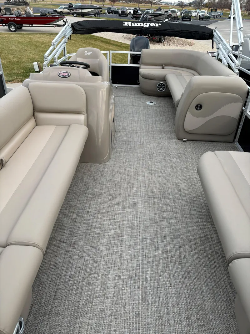 Slide: The Image of 2024 Ranger Reata 200C pontoon boat with spacious seating and modern design. - 5