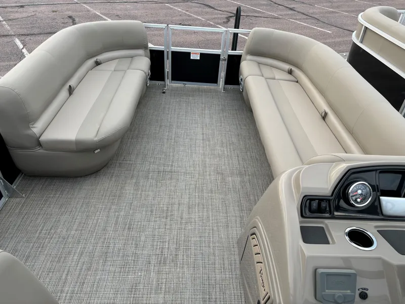 Slide: The Image of 2024 Ranger Reata 200C pontoon boat interior with beige seating and modern dashboard. - 6