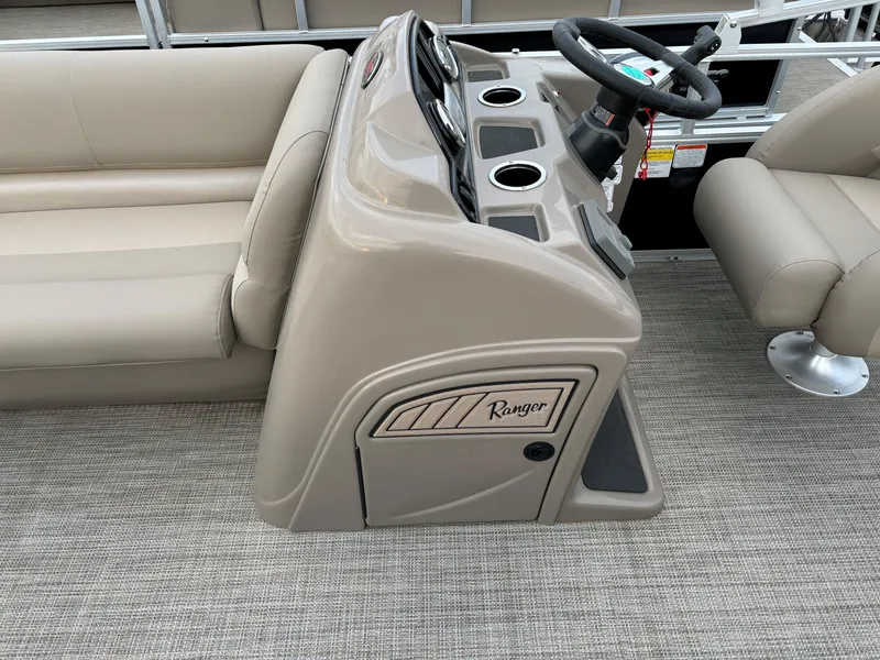 Slide: The Image of 2024 Ranger Reata 200C boat interior with beige seating and steering console. - 8