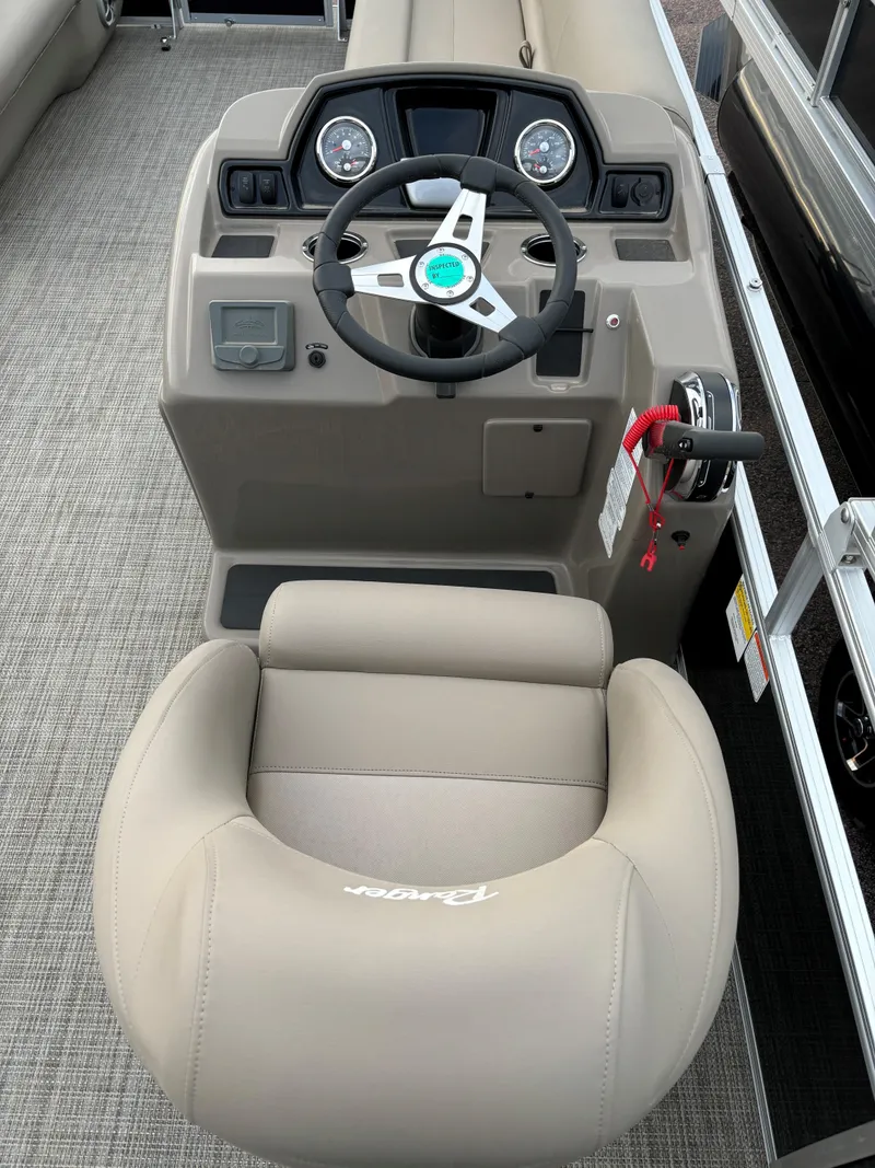 Slide: The Image of 2024 Ranger Reata 200C boat interior with steering wheel and captain's chair. - 9