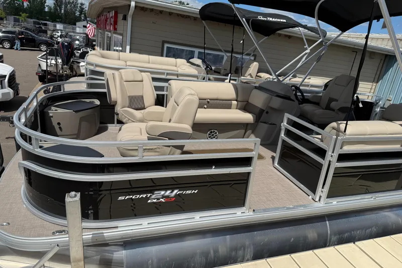The Image of 2024 Sun Tracker Sportfish 24 XP3 pontoon boat with beige seating and black exterior. - 0