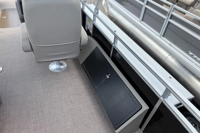 Slide: The Image of 2024 Sun Tracker Sportfish 24 XP3 interior with seating and storage compartment. - 2