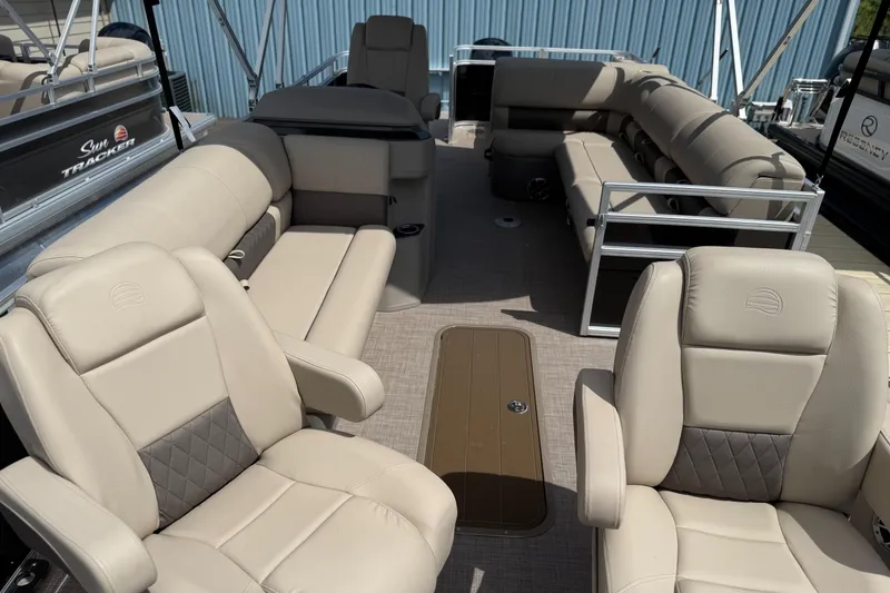 Slide: The Image of 2024 Sun Tracker Sportfish 24 XP3 pontoon boat interior with beige seating and spacious layout. - 3