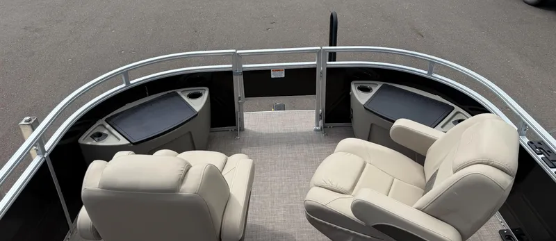 Slide: The Image of 2024 Sun Tracker Sportfish 24 XP3 boat interior with beige seating and storage compartments. - 4