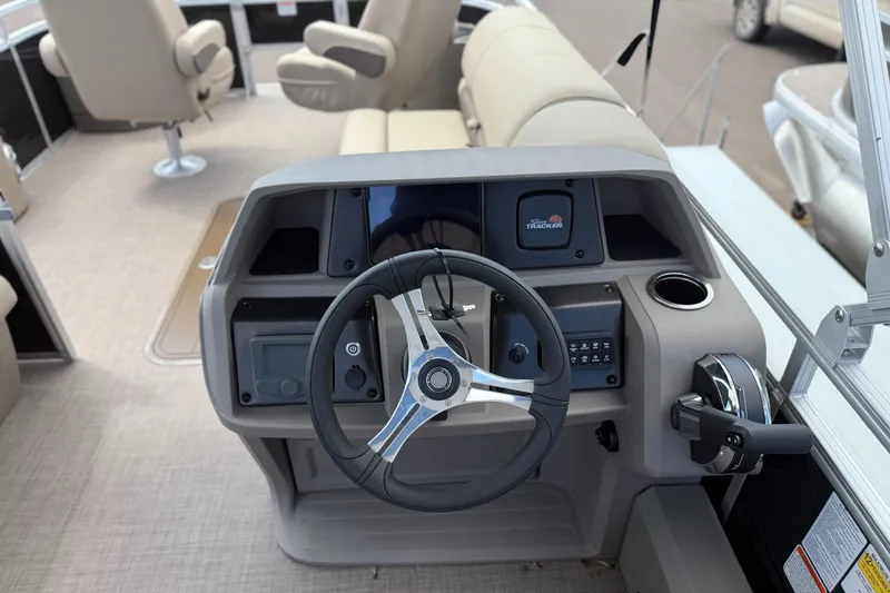 Slide: The Image of 2024 Sun Tracker Sportfish 24 XP3 boat dashboard with steering wheel and controls. - 5