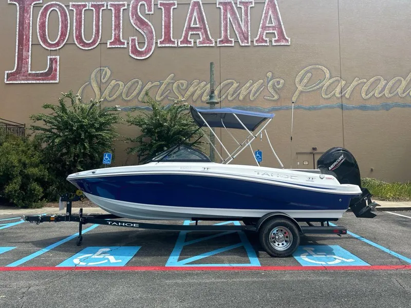 Slide: The Image of 2024 Tahoe 200 S boat on trailer, parked in front of Louisiana Sportsman's Paradise sign. - 0