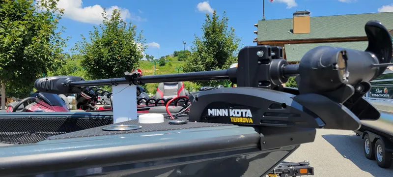 Slide: The Image of 2024 Ranger VS1782SC Angler boat with Minn Kota Terrova motor, parked outdoors under blue sky. - 1