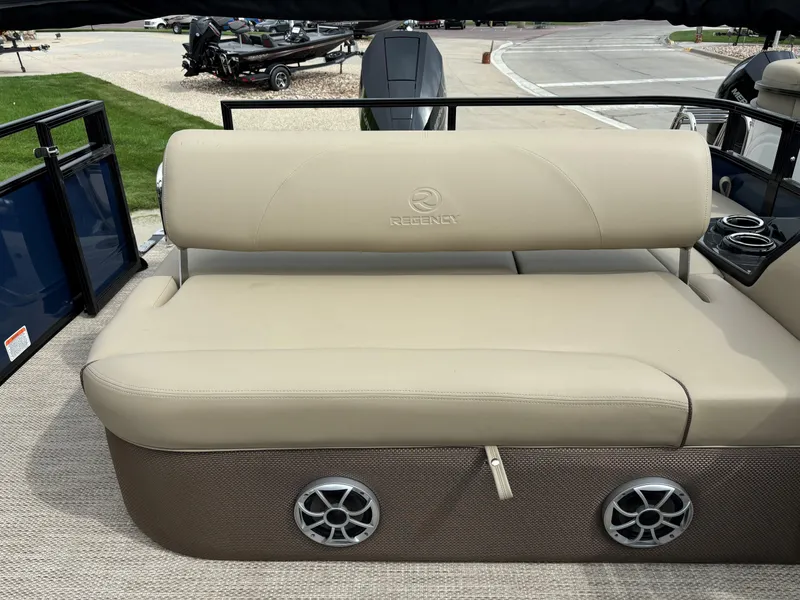 Slide: The Image of 2024 Regency 250 DL3 boat seat with beige upholstery and built-in speakers. - 12