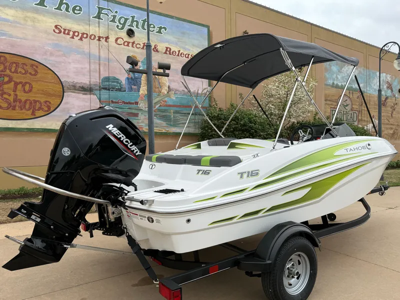 Slide: The Image of 2024 Tahoe T16 boat with Mercury engine on trailer, parked near Bass Pro Shops mural. - 4