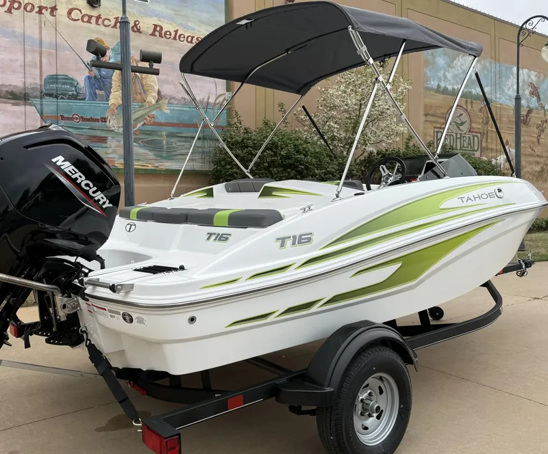 Slide: The Image of 2024 Tahoe T16 boat with green accents on a trailer, featuring a Mercury engine. - 5