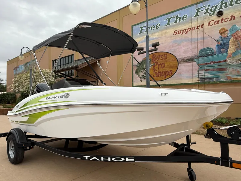 Slide: The Image of 2024 Tahoe T16 boat on trailer, displayed outdoors near a mural. - 7