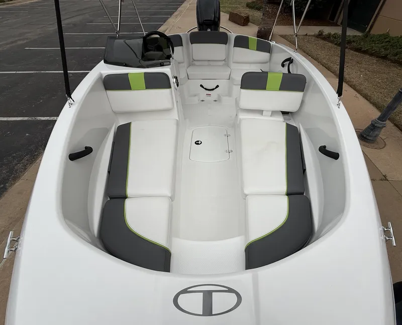 Slide: The Image of 2024 Tahoe T16 boat interior with white and gray seating, green accents. - 8