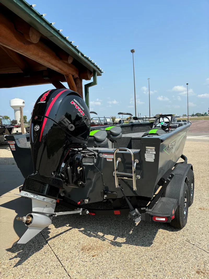Slide: The Image of 2024 Ranger VS1882SC Angler boat with powerful outboard motor, parked outdoors. - 2