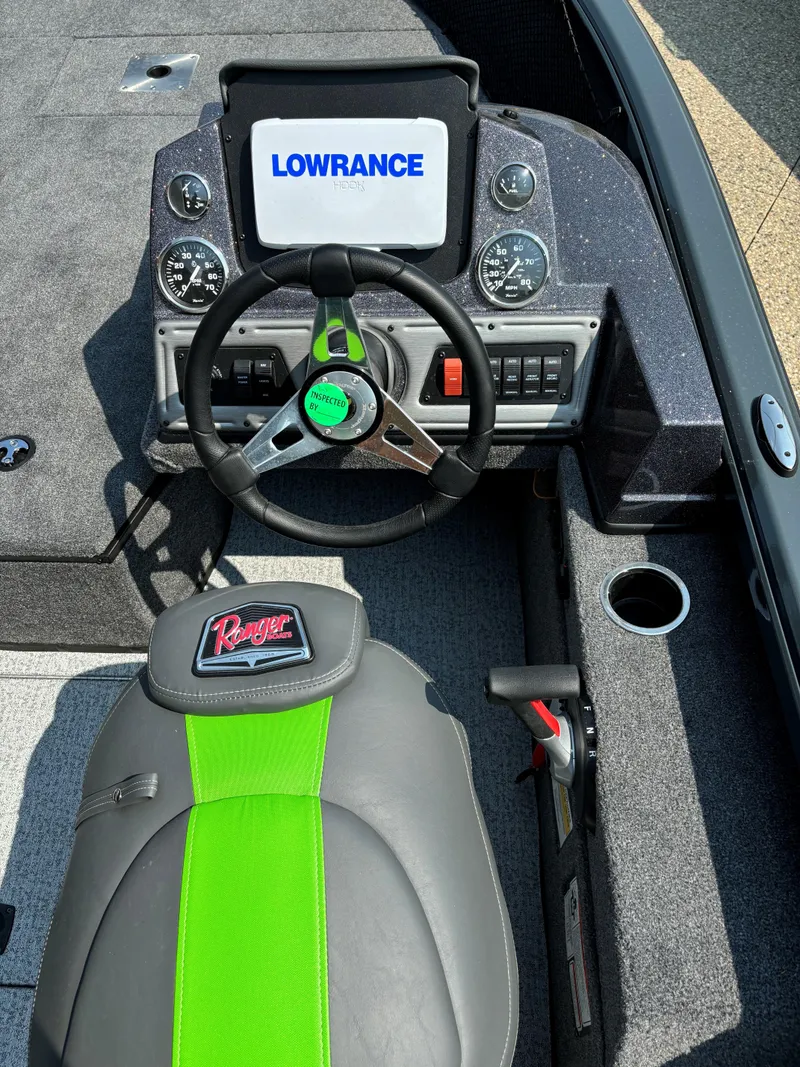 Slide: The Image of 2024 Ranger VS1882SC Angler boat dashboard with Lowrance display and green-accented seat. - 4