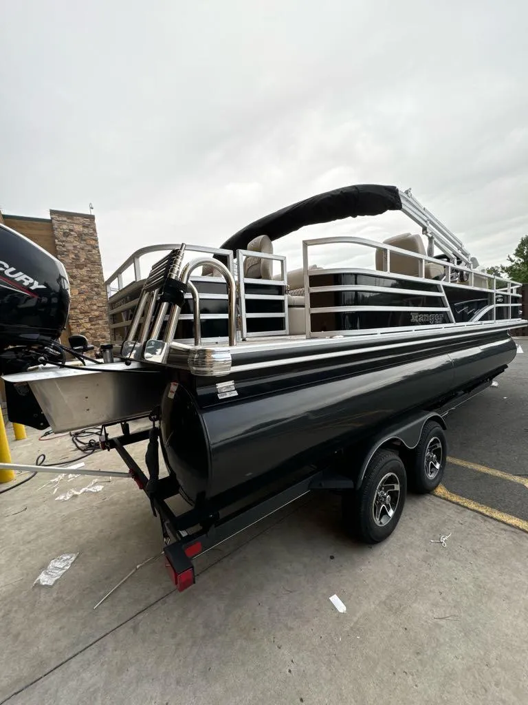 The Image of 2024 Ranger Reata 220F pontoon boat on trailer, featuring sleek design and modern amenities. - 0