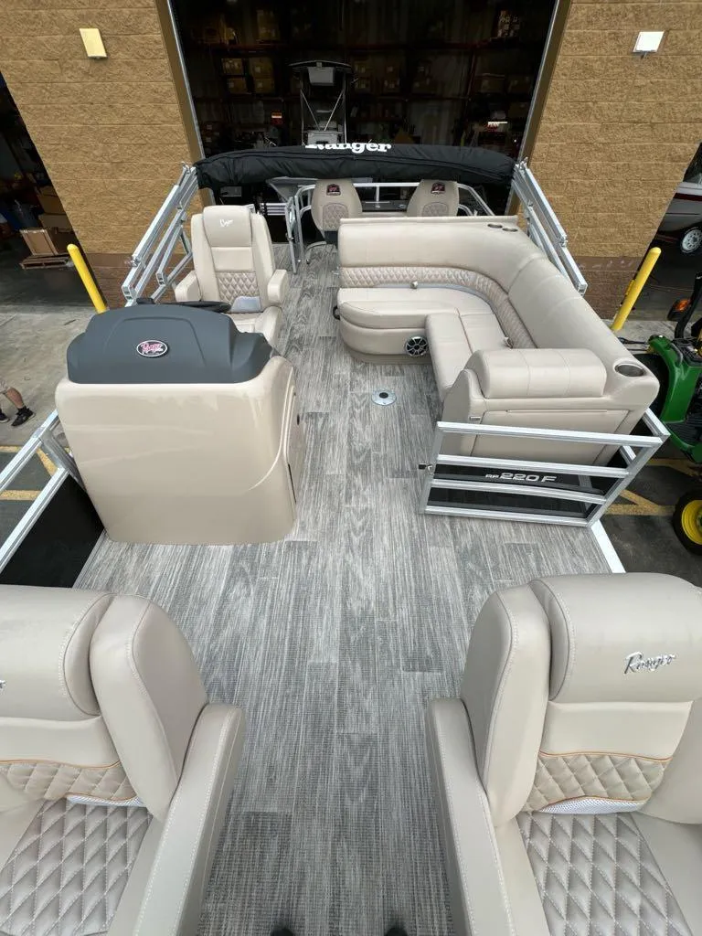 Slide: The Image of 2024 Ranger Reata 220F pontoon boat with spacious seating and modern design. - 2