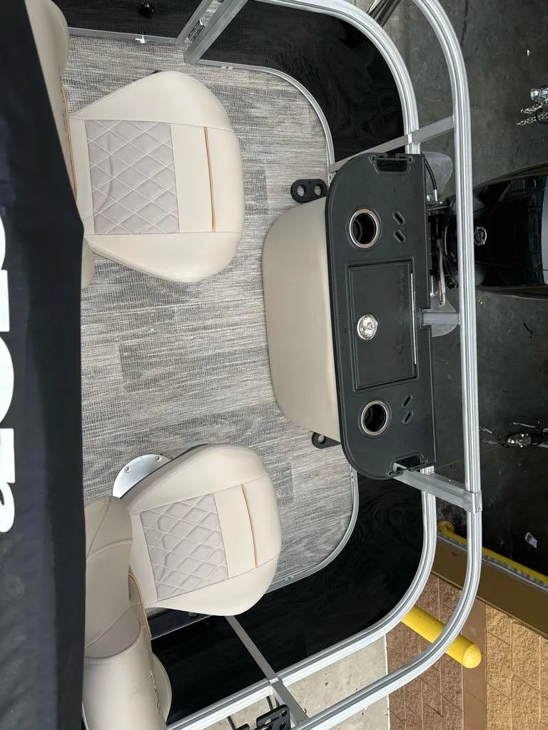 Slide: The Image of 2024 Ranger Reata 220F boat interior with beige seats and control panel. - 3