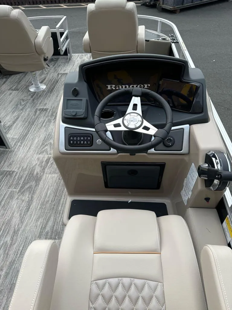 Slide: The Image of 2024 Ranger Reata 220F boat dashboard with steering wheel and controls. - 4
