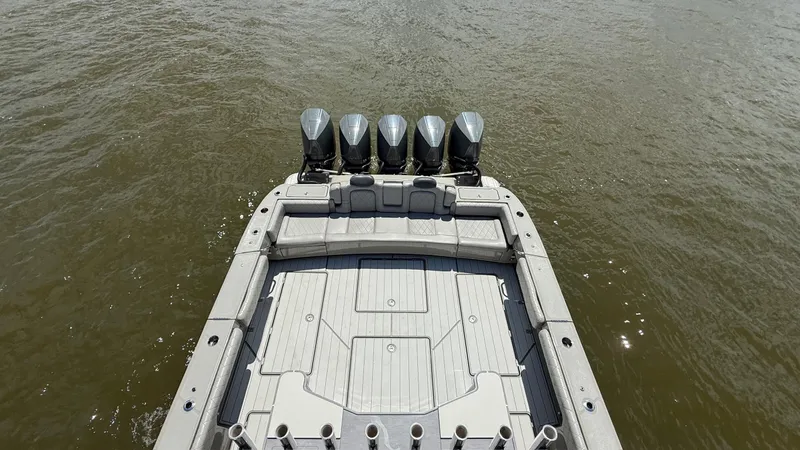 Slide: The Image of 2021 HCB 53 boat with five outboard engines on water. - 12