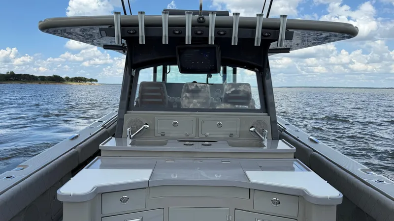 Slide: The Image of 2021 HCB 53 boat interior with sleek design, featuring a modern console and ocean backdrop. - 14