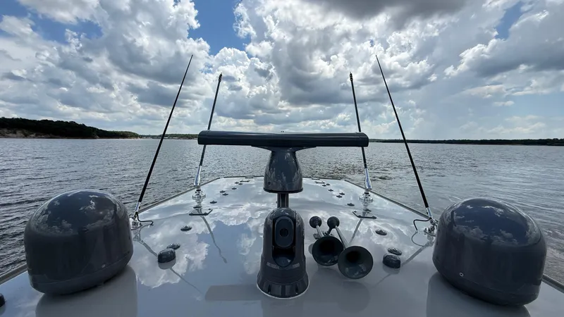 Slide: The Image of Bow view of 2021 HCB 53 boat on a lake under cloudy sky. - 15