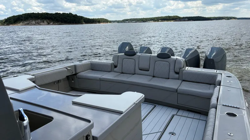 Slide: The Image of Luxurious 2021 HCB 53 boat with spacious seating, cruising on a scenic lake. - 17