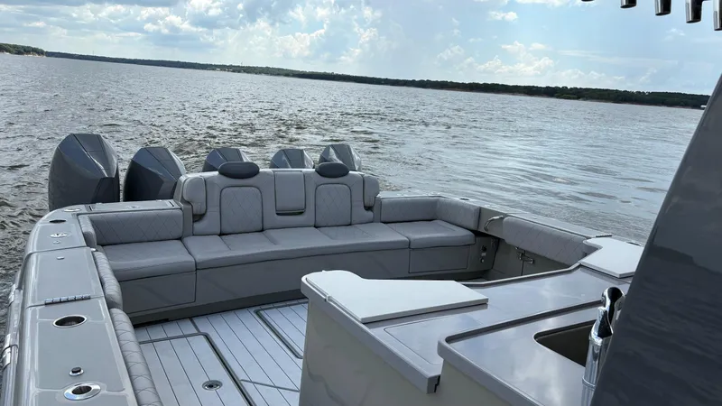 Slide: The Image of Luxurious 2021 HCB 53 boat interior with plush seating, cruising on a serene lake. - 18