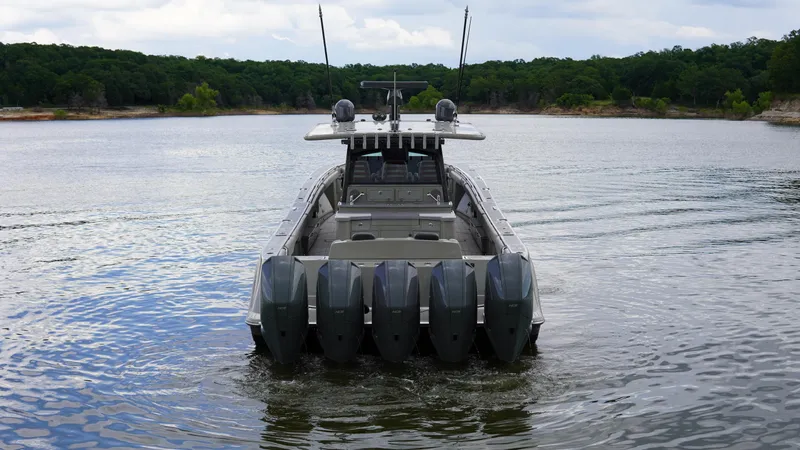 Slide: The Image of HCB 53 boat with multiple engines on a calm lake, 2021 model. - 2