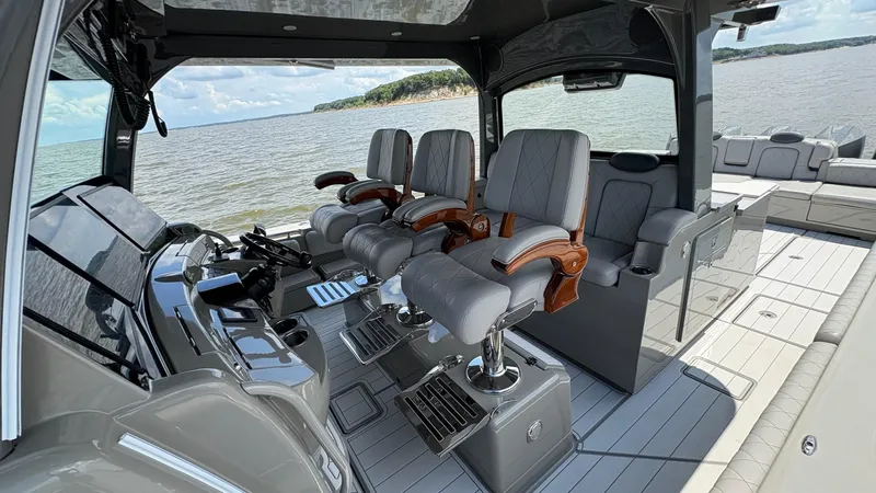 Slide: The Image of Interior of 2021 HCB 53 boat with luxurious seating and helm, overlooking the water. - 21