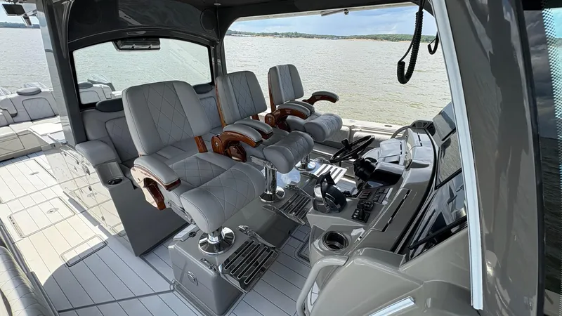 Slide: The Image of Luxurious interior of a 2021 HCB 53 boat with plush seating and advanced controls. - 23
