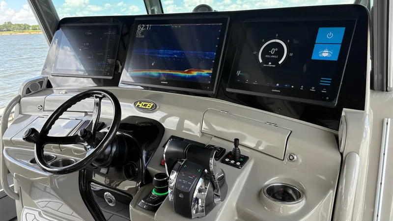Slide: The Image of Helm of 2021 HCB 53 boat with advanced navigation displays and controls. - 24