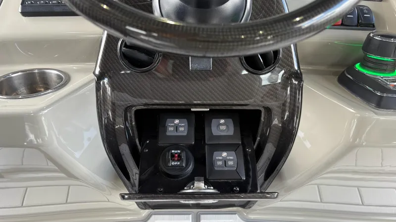 Slide: The Image of Control panel of 2021 HCB 53 boat with steering wheel and switches. - 27