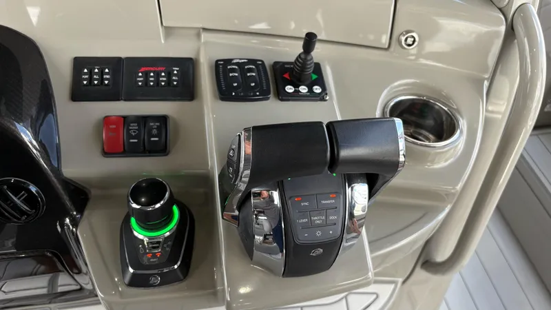 Slide: The Image of Control panel of a 2021 HCB 53 boat with throttle and joystick. - 28