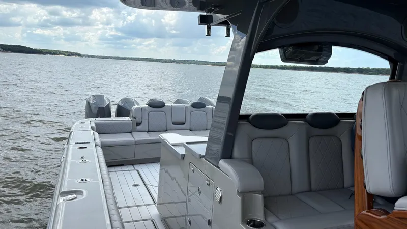 Slide: The Image of Luxurious 2021 HCB 53 boat interior with plush seating on a serene lake. - 32