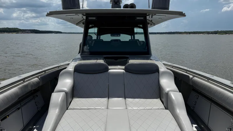 Slide: The Image of 2021 HCB 53 boat with luxurious seating on a calm lake. - 40