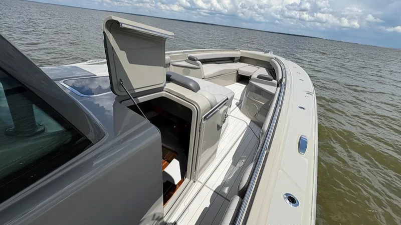 Slide: The Image of 2021 HCB 53 boat with open hatch, luxurious seating, and ocean view. - 44