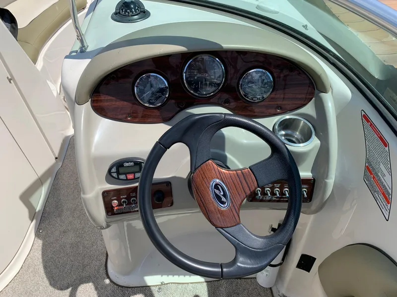 Slide: The Image of 2005 Sea Ray 220 Sundeck dashboard with steering wheel and instrument panel. - 4