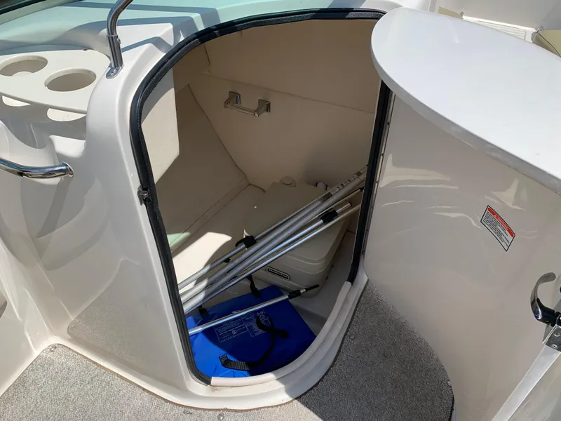 Slide: The Image of 2005 Sea Ray 220 Sundeck storage compartment with ladder and equipment. - 7
