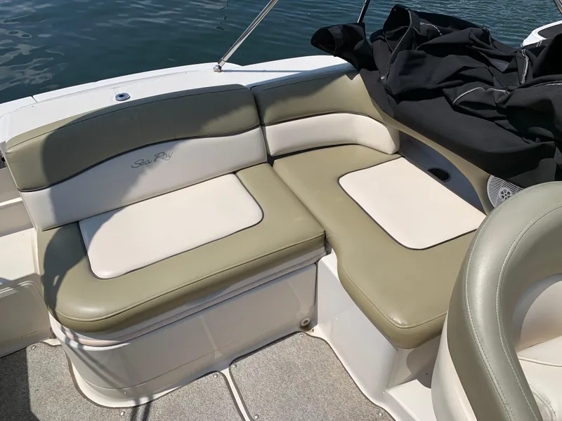 Slide: The Image of 2005 Sea Ray 220 Sundeck boat interior with beige and white seating. - 8