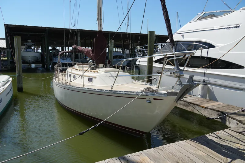 The Image of 1970 Cheoy Lee 38A sailboat docked in a marina, surrounded by other boats. - 1